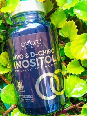 Oxford Origins Myo & D-Chiro Inositol Complex for Women bottle placed among green leaves, dietary supplement with 90 specialized capsules made in Britain.